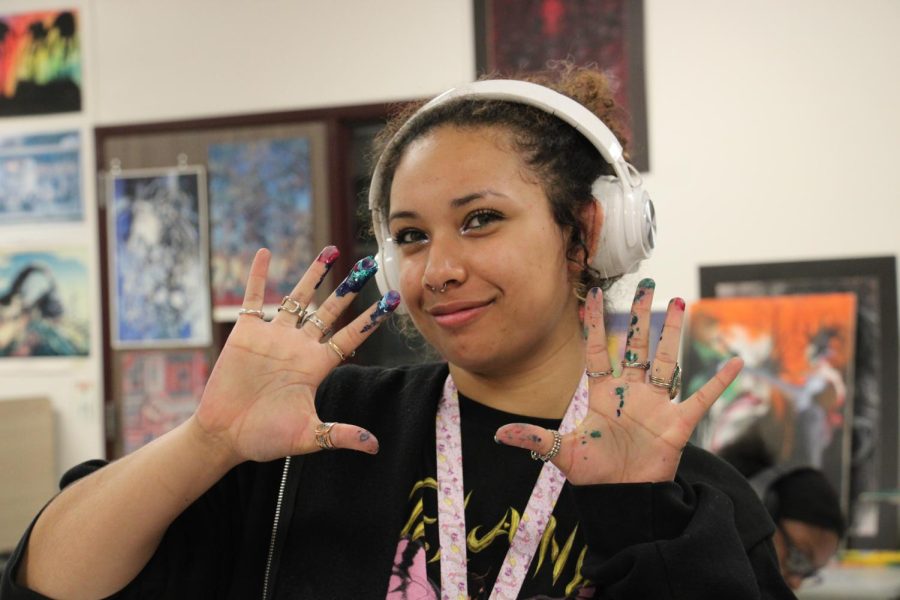 Senior Mya Jones flaunts the colors smeared on her hands.