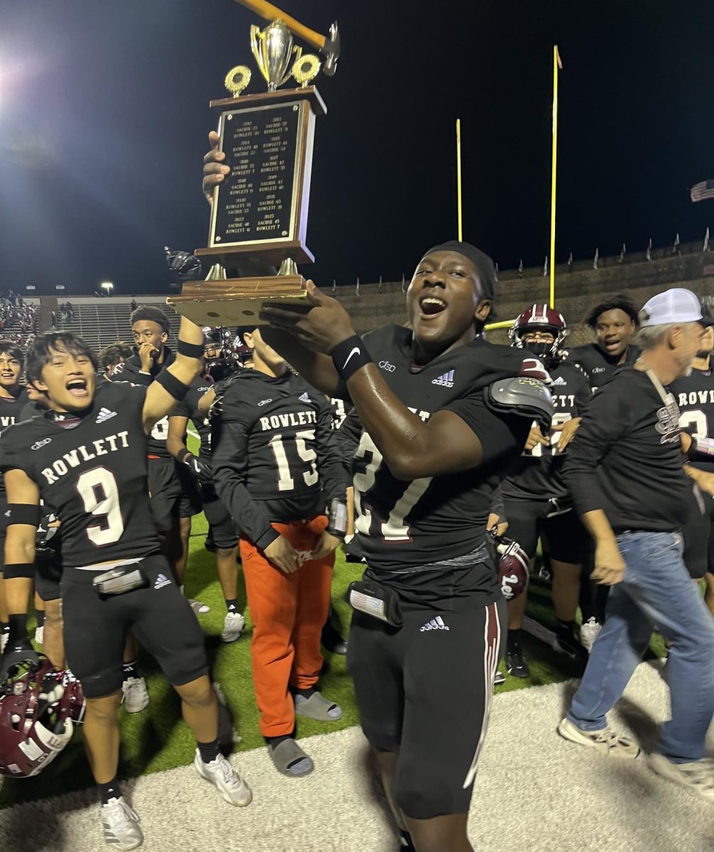 The Football team celebrate as they hold the Hammerle trophy.